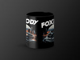 Black mug with "FOXY BODY" text and custom car artwork.