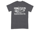 Dark t-shirt with a graphic of a classic truck flying an American flag with city skyline and "Legends Never Die" text.