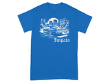 Blue t-shirt with a graphic of a classic car in a city with the word "Impala."