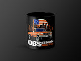 Black mug featuring orange truck, US flag, and city skyline with text "Obsession Powerstroke Single Cab".