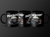 Three black mugs with a stylized car and city skyline design, featuring "FOXBODY" text.