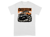 Orange pickup truck off-roading over rocks with "OBSESSION" text graphic.