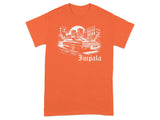 Orange t-shirt with white graphic of a classic Impala car and cityscape.
