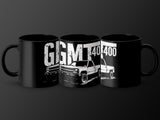 Three black mugs with white graphics of trucks and text "GGMT 400"