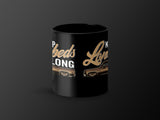 Black mug with text "Keep Beds Long" and images of classic brown pickup trucks.