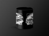 Black mug featuring two vintage pickup truck illustrations with brick road accents.
